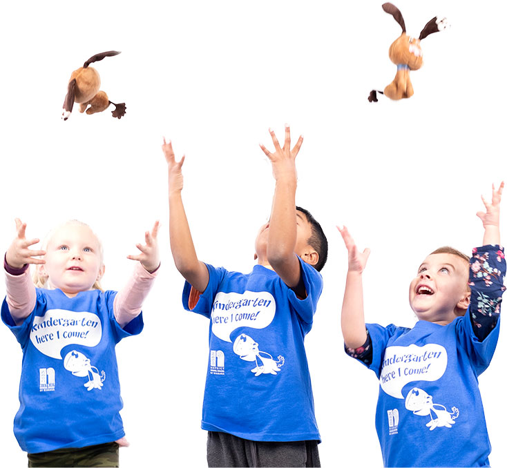 children throwing toy dogs in air