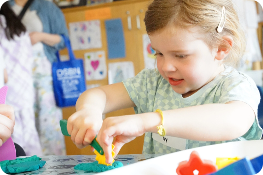 A kindergarten student playing in a classroom