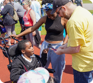 man awarding ribbon to a participant