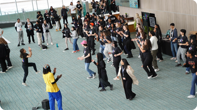 Picture taken from above of RISE Up group of students clapping