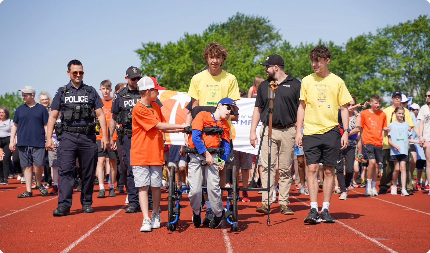 Special Olympics group photo with torch bearer and polic