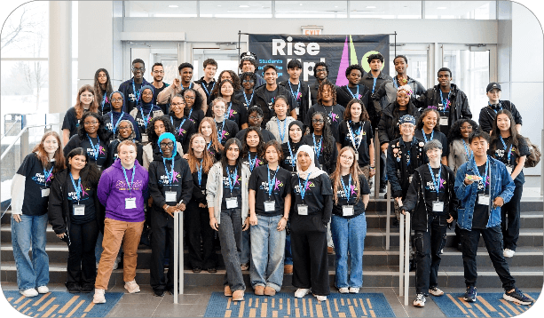 Large group of students gathered on a staircase at the DSBN Student Equity Conference, posing in front of a “Rise Up” event banner.