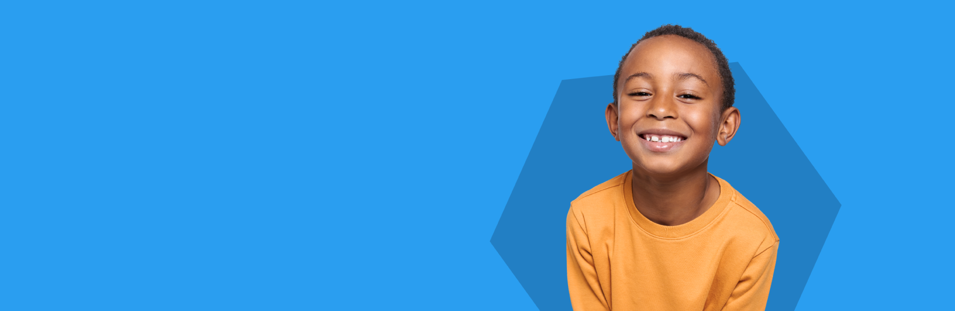 Child wearing an orange shirt against a blue background.